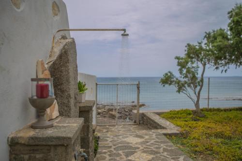a view of the ocean from a building with a water fountain at Villa Pelagos in Koutsounari