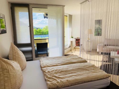 a bedroom with two beds and a view of a pool at Private Suite im Gebäude des Graf Eberhard Hotels in Bad Urach
