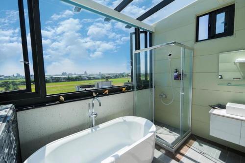 a large bathroom with a tub and a window at 澳玩客電梯民宿 in Wujie