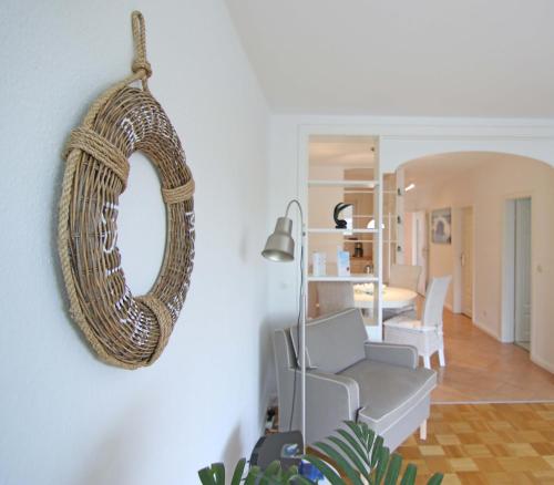 a mirror hanging on a wall in a living room at Backbord by WellenRausch in Travemünde