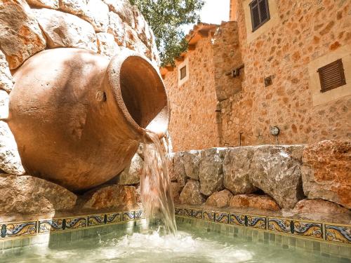 a water fountain in front of a stone building at Finca Ses Fontanelles in Andratx