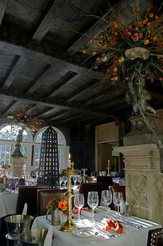 a dining room with a table with wine glasses at The Witchery by the Castle in Edinburgh