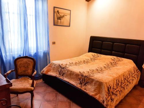 a bedroom with a bed and a chair at Luna Ridens in Alberese
