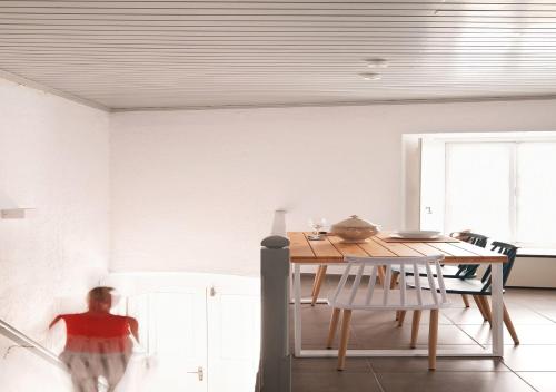 a person walking around a dining room table at Keresbino Hydra Port House in Hydra
