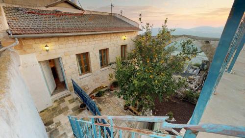 a view of a house from a balcony with a tree at HEMDAT NEFESH in Safed