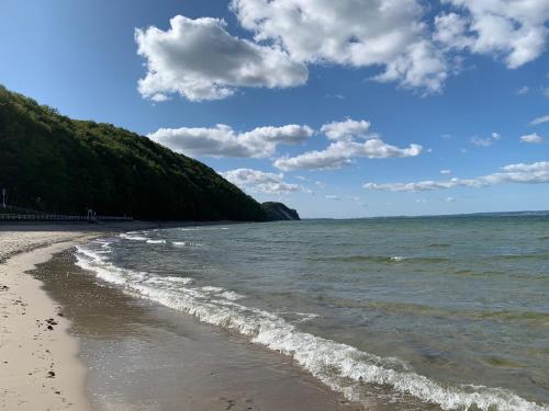 a beach with the ocean and a cloudy sky at Appartementanlage Lancken-Granitz in Lancken-Granitz
