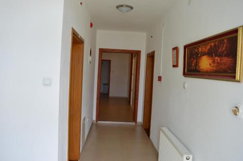a hallway with a painting on the wall and a hallway with a hallway at Motel Signal in Banja Luka