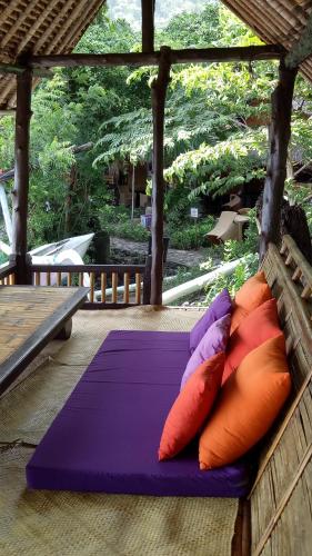 a bunch of pillows are sitting on a bench at Good Karma Bungalows in Amed