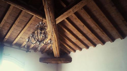 a wooden ceiling with a chandelier hanging from it at Luna Ridens in Alberese