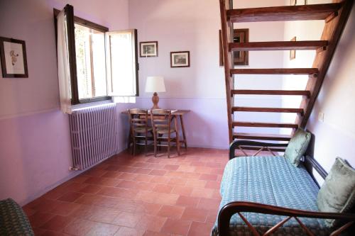 a room with a staircase and a table and a window at Malvarina in Capodacqua