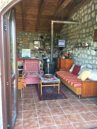 a living room with a couch and a table at Rent House Orahovo in Virpazar