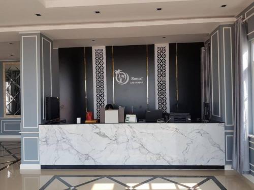 a lobby with a white marble counter in a building at Sunset Mekong Apartment in Vientiane