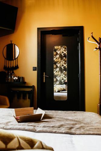 a bedroom with a door with a book on a bed at La villa 10 HÔTEL SPA in Étretat