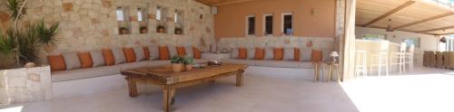 a living room with a couch and a table at Amatu Villa (Athena) in Xerokampos