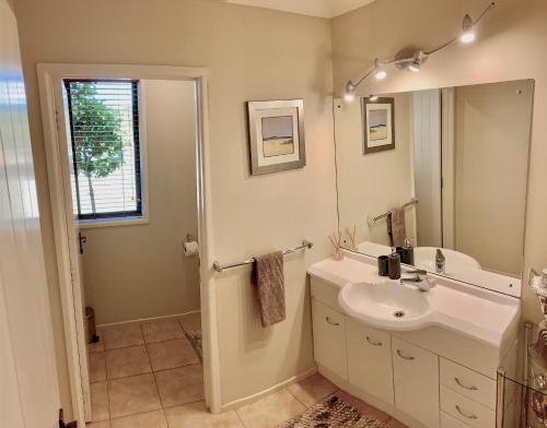 a bathroom with a sink and a mirror at Heaven's Rest B&B in Pukekohe East