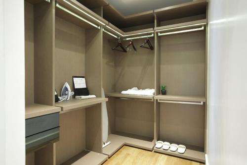 a walk in closet with shelves and hangers at Residence26 in Yangon