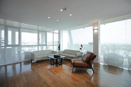 a living room with a couch and a table and chairs at Residence26 in Yangon