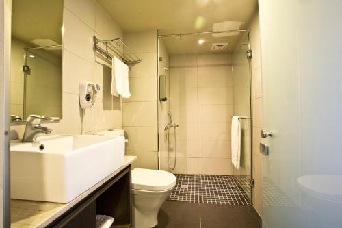 a bathroom with a sink and a toilet and a shower at Fine Hotel in Kaohsiung