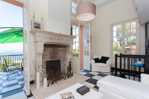 un salon avec une cheminée et un canapé dans l'établissement La Petite Fontaine, à Théoule-sur-Mer