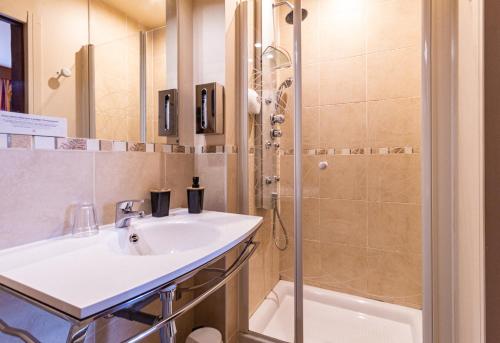 a bathroom with a sink and a shower at La Villa in Rouen