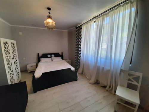 Un ou plusieurs lits dans un hébergement de l'établissement Guesthouse of Manoni Ratiani