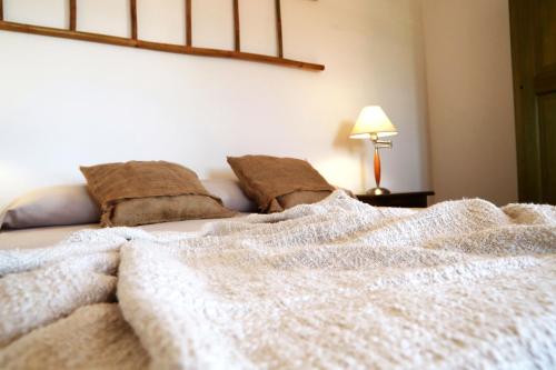 a bed with a blanket on top of it at Agriturismo Francesca Stajano in Alezio
