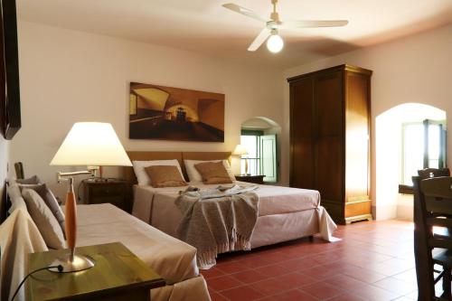 a bedroom with two beds and a ceiling fan at Agriturismo Francesca Stajano in Alezio