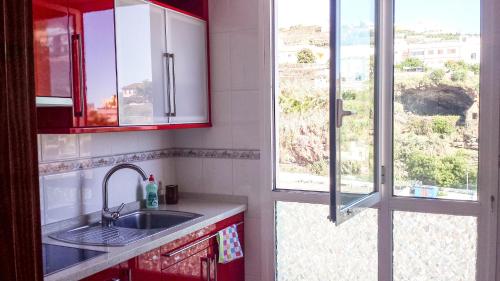a kitchen with a sink and a window at Apartamento ARENA en Santa Cruz de la Palma in Santa Cruz de la Palma