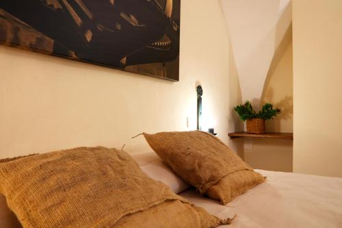 a bedroom with a bed with two pillows on it at Agriturismo Francesca Stajano in Alezio