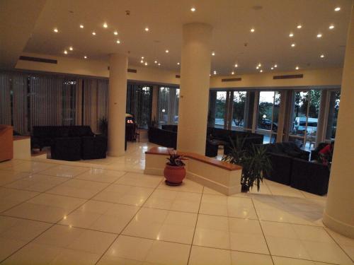 a lobby with couches and tables in a building at Eleftheria Hotel in Agia Marina Nea Kydonias
