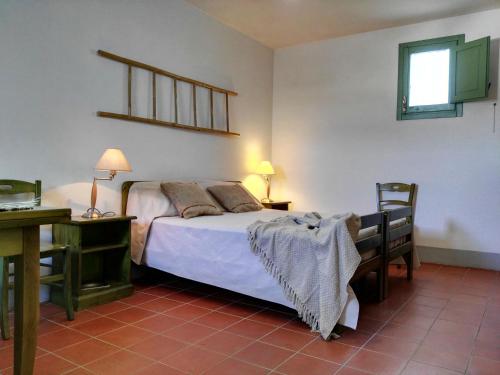 a bedroom with a bed and a desk with two lamps at Agriturismo Francesca Stajano in Alezio