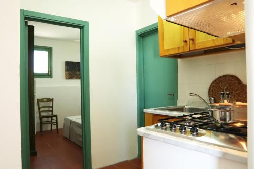 a kitchen with a stove and a counter top at Agriturismo Francesca Stajano in Alezio