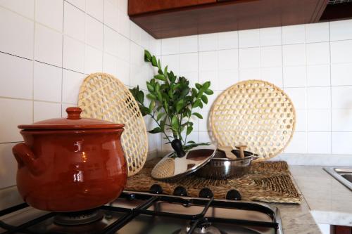 a kitchen with three baskets on a stove top at Agriturismo Francesca Stajano in Alezio