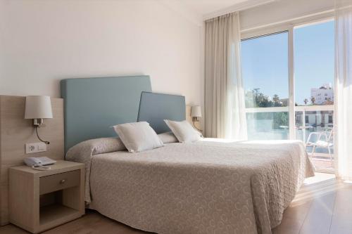 Postel nebo postele na pokoji v ubytování Hotel Palia Las Palomas