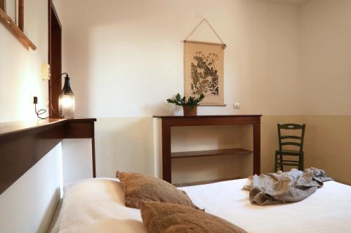 a bedroom with a bed and a desk and a chair at Agriturismo Francesca Stajano in Alezio