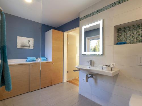 a bathroom with a tub and a sink and a shower at Appartements Bank am See in Immenstaad am Bodensee