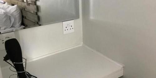 a kitchen with a white counter and a black phone at George Executive Suites in George