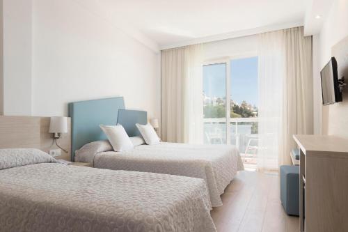 Postel nebo postele na pokoji v ubytování Hotel Palia Las Palomas
