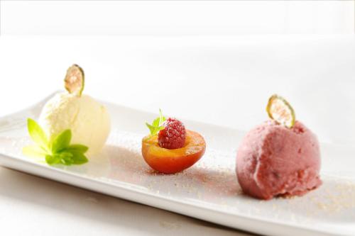 a plate with three different types of food on it at Genuss- & Aktivhotel Sonnenburg in Riezlern