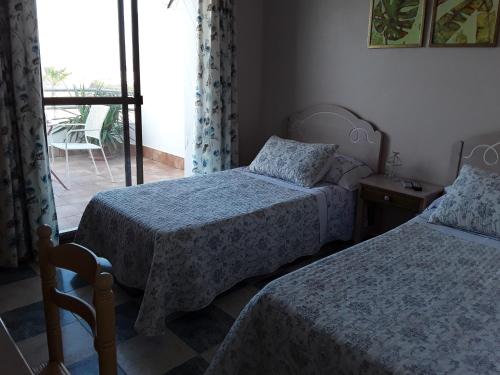 Ένα ή περισσότερα κρεβάτια σε δωμάτιο στο pension hernandez