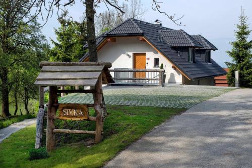 a house with a sign in front of it at Apartments Sivka - Private Sauna in Cerklje na Gorenjskem