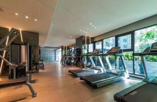 a gym with several treadmills and elliptical machines at the base in Pattaya Central