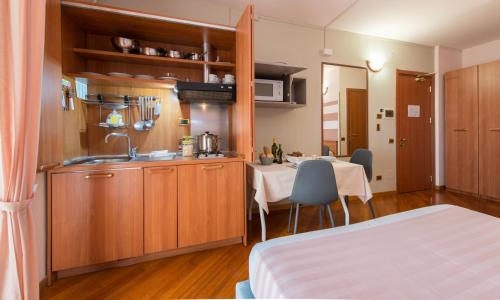 a kitchen with a sink and a table in a room at Loano 2 Village in Loano