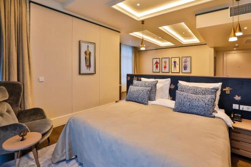 a bedroom with a large bed and a chair at Dreamland Golf Hotel Baku in Baku