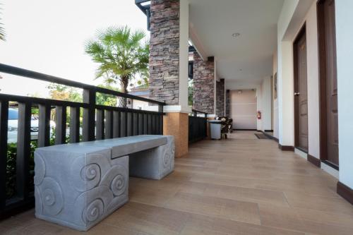 a porch with a bench on a balcony at Fortune Surin Hotel in Surin
