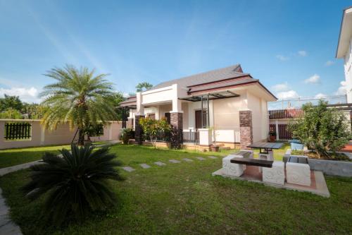 a house with a garden in front of it at Fortune Surin Hotel in Surin