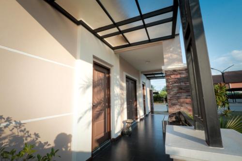 a hallway of a house with a glass door at Fortune Surin Hotel in Surin