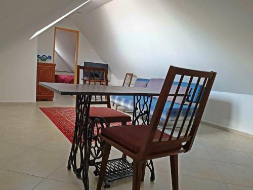 a dining room table and chairs in a room at Gomi 20 in Tbilisi City