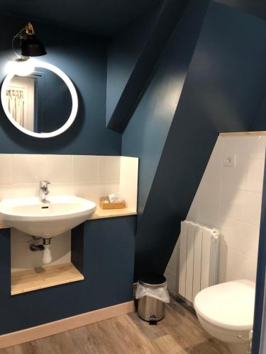 a bathroom with a sink and a toilet at Hotel Linette in Aumont-Aubrac