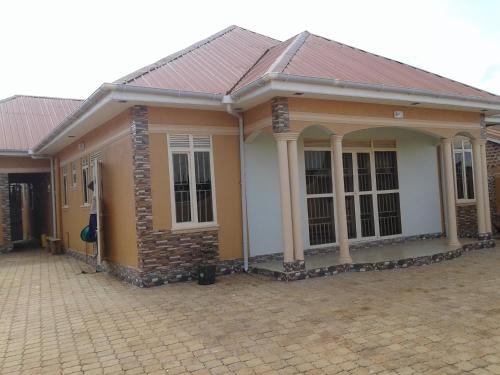 a small house with a tile roof at FREEDOM Guest House in Wakiso